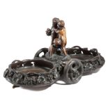 A BLACK FOREST CARVED WOOD WINE DECANTER WAGON C.1880 the centre with three frolicking