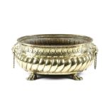A DUTCH BRASS OVAL JARDINIERE 19TH CENTURY with repousse decoration, lion's mask ring handles and on