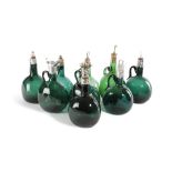 A COLLECTION OF GREEN GLASS SPIRIT DECANTERS 19TH CENTURY AND LATER in the form of flagons, with