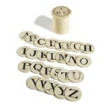 A BONE SPELLING ALPHABET EARLY 19TH CENTURY with twenty-six double sided counters contained in a