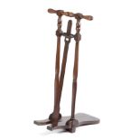 A MAHOGANY BOOT JACK with a turned handle and supports, with an applied ivorine plaque, inscribed '