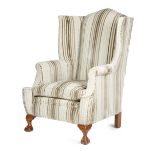 A WING ARMCHAIR IN GEORGE II STYLE FIRST HALF 20TH CENTURY with scroll arms, on cabriole front