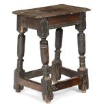 A 17TH CENTURY OAK JOINT STOOL C.1620-40 the seat with a moulded edge, above a moulded rail and on