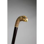 A NOVELTY WALKING CANE C.1930 the faux shagreen handle in the form of a parrot's head, with glass