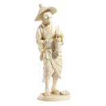 λ A JAPANESE IVORY OKIMONO OF AN OLD MAN MEIJI 1868-1912 carved standing and holding a lantern and