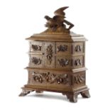 A BLACK FOREST WALNUT JEWELLERY BOX LATE 19TH / EARLY 20TH CENTURY the hinged lid carved with a