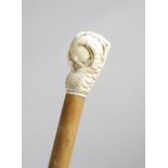 λ A LATE VICTORIAN IVORY HANDLED WALKING CANE C.1880 carved in the form of an eagle's claw and ball,