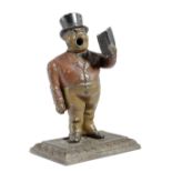 A PAINTED CAST IRON CIGAR CUTTER LATE 19TH CENTURY in the form of a town crier, wearing a top hat,