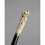 λ A JAPANESE IVORY HANDLED WALKING CANE MEIJI 1868-1912 carved with two frogs, a skull, carp, a