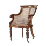 A WILLIAM IV MAHOGANY BERGERE C.1835-40 with a curved scroll top rail above a caned back and seat,