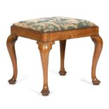 A GEORGE II WALNUT STOOL C.1730-40 with a later needlework drop-in seat, on cabriole legs and pad