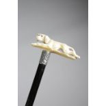 λ A LATE VICTORIAN IVORY HANDLED WALKING CANE C.1897 carved with a running retriever dog, with glass