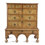 A QUEEN ANNE WALNUT CHEST ON STAND C.1710 with cross and feather banding, the quarter veneered top