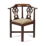 AN EARLY GEORGE III MAHOGANY CORNER CHAIR C.1760-70 the curved top rail above a twin pierced splat