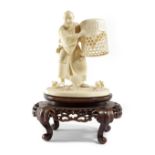 λ A JAPANESE IVORY OKIMONO GROUP OF A CHICKEN CATCHER MEIJI 1868-1912 carved with a man in a full