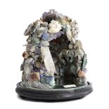 A SPECIMEN MINERAL 'GROTTO' GROUP containing assorted minerals, including: quartz crystal,