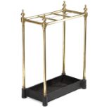 A BRASS STICKSTAND LATE 19TH / EARLY 20TH CENTURY with six divisions and a cast iron base 60.5cm