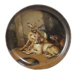 A VICTORIAN PAPIER-MACHE SHALLOW BOWL C.1860 painted with four dogs in an interior setting, in the