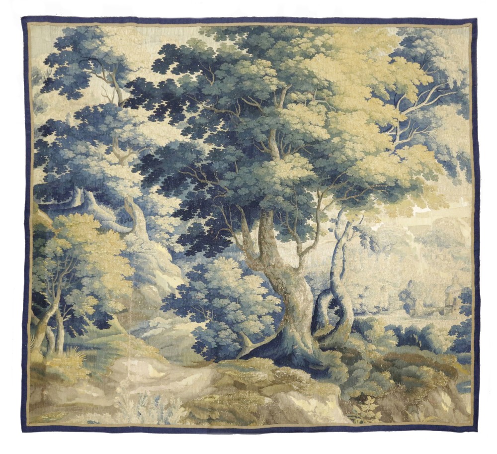 A FLEMISH VERDURE TAPESTRY 17TH CENTURY worked with trees and with a castle in the distance 226.8