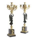 A PAIR OF FRENCH 'EMPIRE' GILT AND PATINATED BRONZE CANDELABRA C.1830-40 each with a winged figure