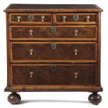 A WILLIAM AND MARY WALNUT OYSTER VENEERED CHEST C.1690 inlaid with holly banding and stringing,