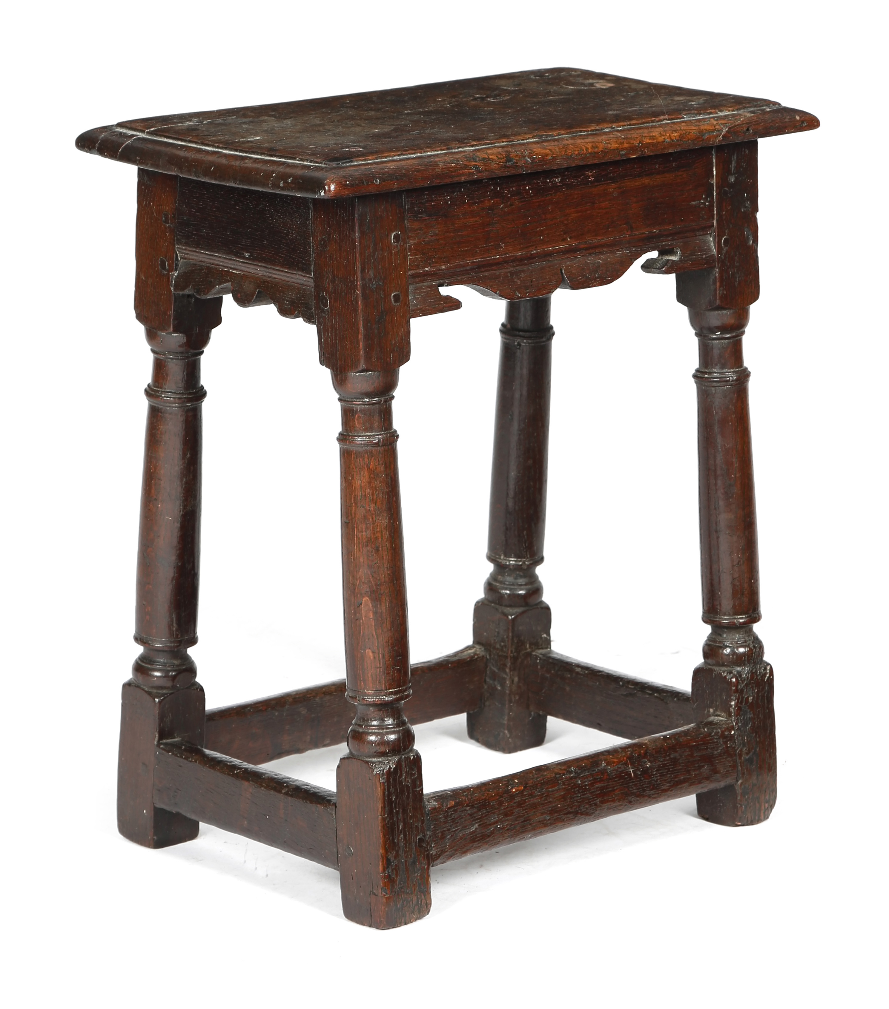 A CHARLES I OAK JOINT STOOL C.1630 the top with a moulded edge, above bi-cuspid shaped rails, on