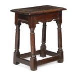 A CHARLES I OAK JOINT STOOL C.1630 the top with a moulded edge, above bi-cuspid shaped rails, on