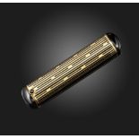 An Art Deco gold lipstick holder by Cartier, of cylindrical form, with black enamel decoration and