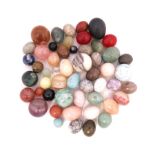 A collection of assorted polished hardstone eggs and spheres