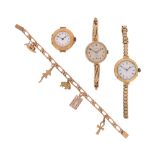 A yellow gold flat curb link bracelet with five gold charms, and three gold ladies wristwatches, one