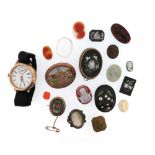 A gold fob watch on velvet strap and a collection of carved hardstone and paste gems