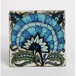 A William De Morgan Sands End Pottery large tile, painted with a fan flower in blue, green and black