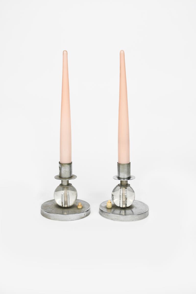 A pair of Modernist chrome and glass candlestick table lamps in the manner of Maison Desny, circular