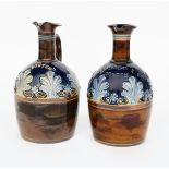 A pair of Doulton Lambeth stoneware water jugs, one titled Scotch the other Grant Mackay & Cos