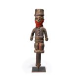 An Ibibio marionette Nigeria with an articulated jaw, now with a cloth repair, with remains of