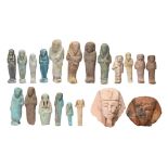 A collection of Egyptian shabtis glazed and un-glazed, one with painted hieroglyphs and three with