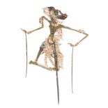 A Java wayang kulit shadow puppet Indonesia painted cut out leather with horn supports, representing
