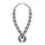 A Navajo squash blossom necklace Southwest, North America silver and turquoise, the stylised blossom