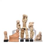 A collection of nine figures Hellenistic and later terracotta and pottery, including a reclining