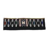 An East Africa beaded skirt black fabric with coloured glass and plastic beads, 31 x 101cm.