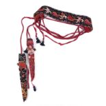 An Uzbek belt with two knife cases woven dyed wools depicting fruit and foliate designs,