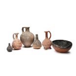 Six Cypriot pottery vessels circa 2000 - 1650 BC comprising a red polished handled jug with