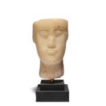 A South Arabian style alabaster bust 21cm high, on a stepped base.