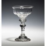 A baluster sweetmeat glass c.1740, the panel moulded bowl raised on a baluster stem above a domed