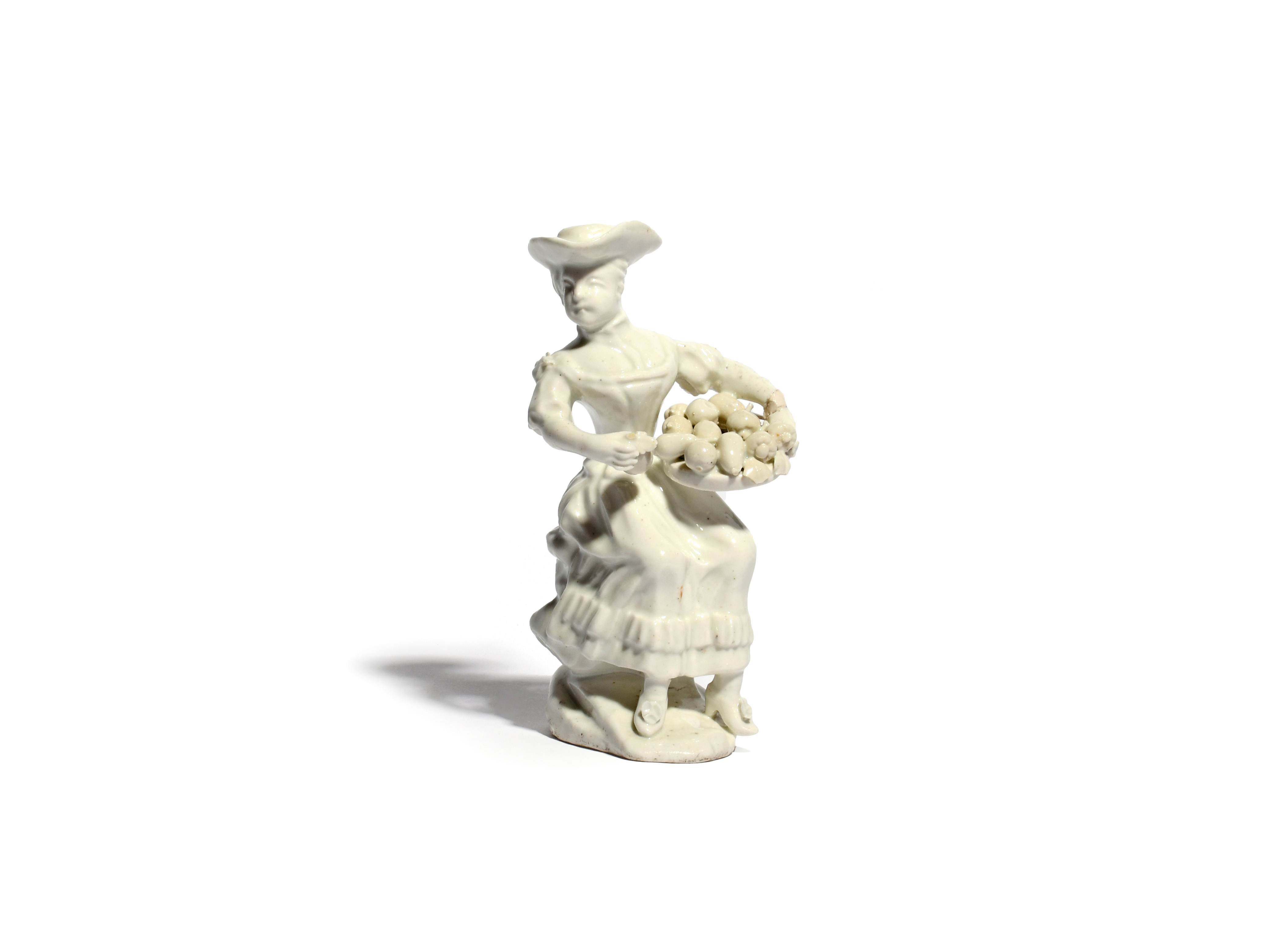 A white-glazed Orleans figure of a fruit seller c.1767, probably modelled by Pierre Renault,