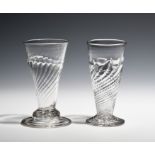 Two early dwarf ale glasses c.1700-30, one with a wrythen bowl above a domed and folded foot, the