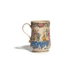 A Staffordshire salt-glazed mug c.1760-70, the slightly waisted form enamelled with flowering