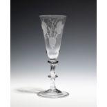 A balustroid ale glass c.1750, the round funnel bowl engraved with hops and barley above a triple-