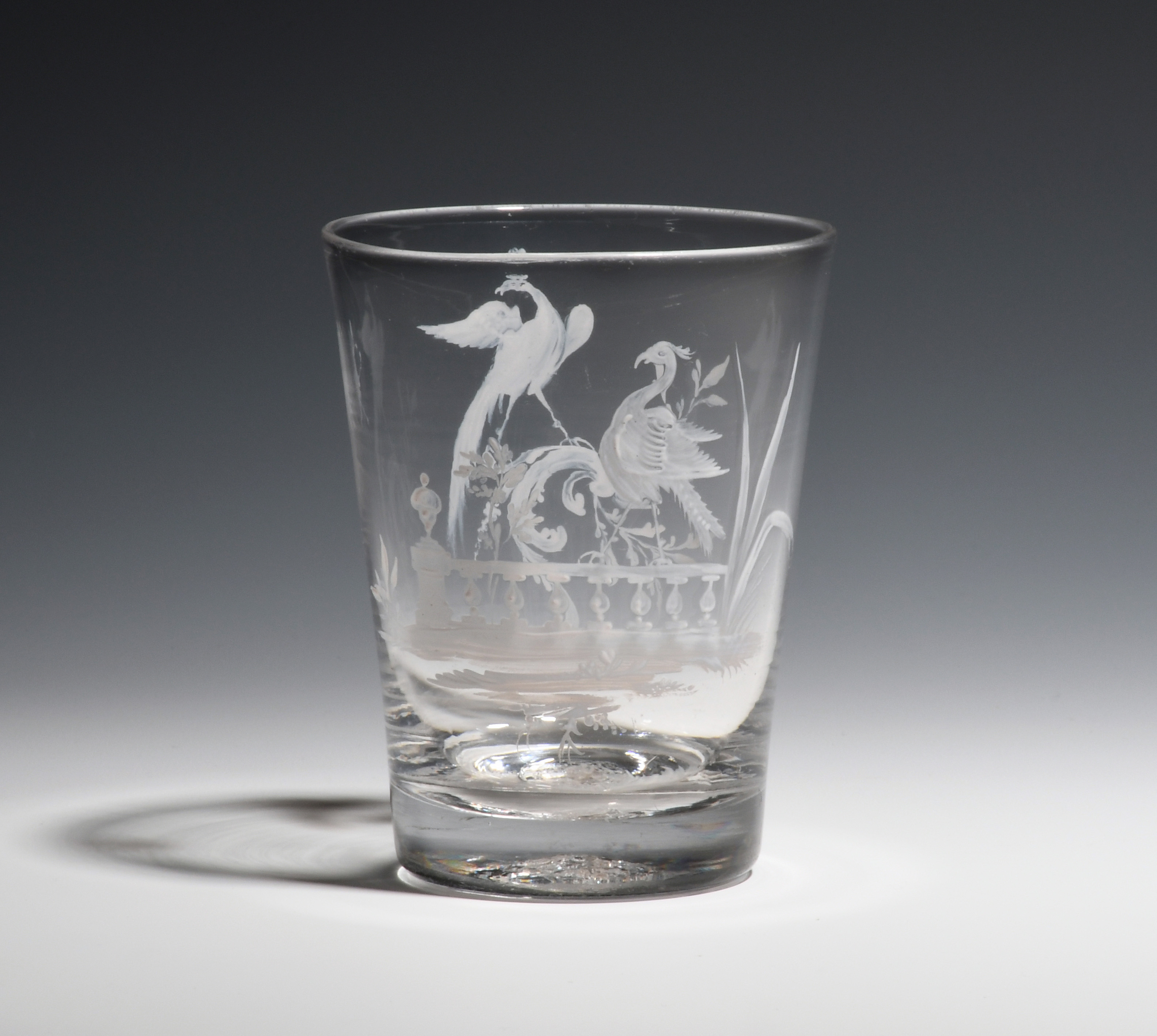 A Beilby tumbler or beaker c.1765, the flared form enamelled in white with two exotic birds above