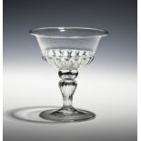 A thinly blown sweetmeat glass c.1690, the gadrooned bowl raised on a wrythen stem above a folded